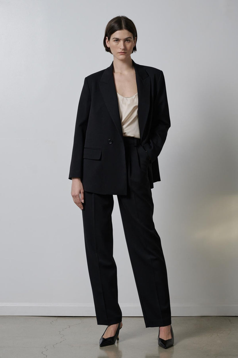 Woman wearing a Velvet by Jenny Graham FAIRFAX blazer and silk blouse, with structured shoulders.