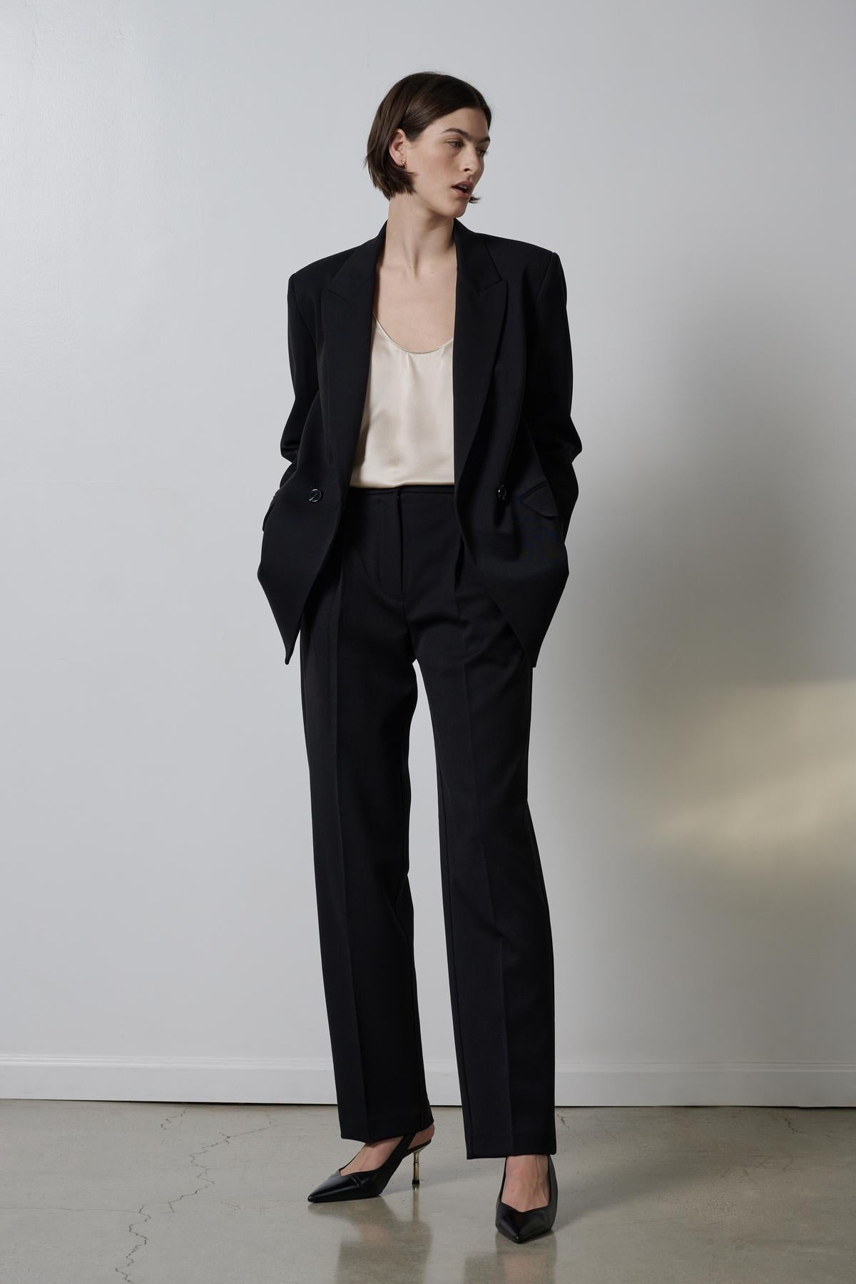 A model wearing the Velvet by Jenny Graham BUNDY PANT and a white blouse.-26827819843777