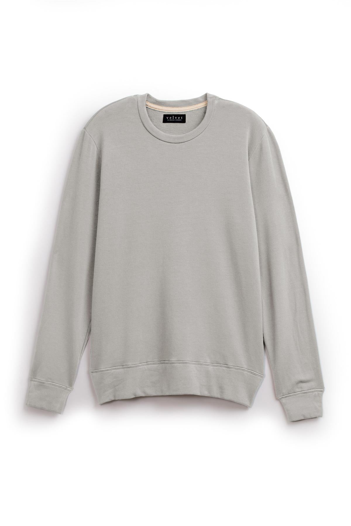   The SOREN PULLOVER by Velvet by Graham & Spencer is a plain gray sweatshirt featuring a crew neck and long sleeves, designed with an extra soft luxe fleece for ultimate comfort and a cozy brushed interior, all showcased on a white background. 