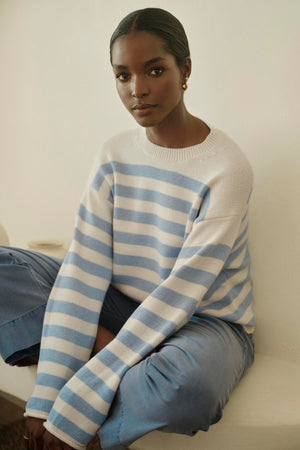 A woman wearing a blue and white striped sweater paired with MYA COTTON CANVAS PANTS by Velvet by Graham & Spencer.