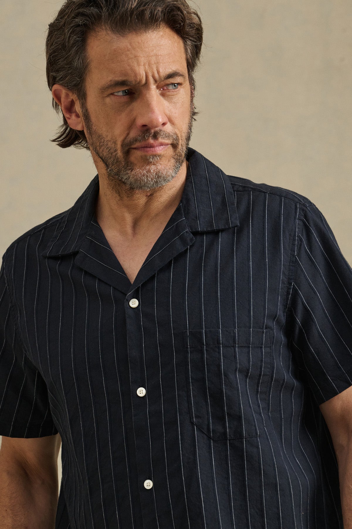 A man with short brown hair and a beard wears the GUNNER SHIRT by Velvet by Graham & Spencer, looking to the side against a neutral background.-41548218433729