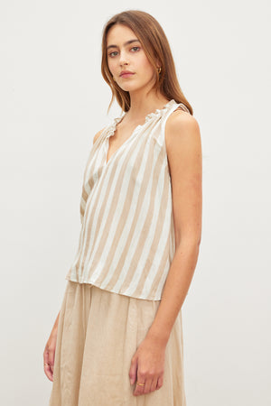 Woman posing in a Velvet by Graham & Spencer ERICA STRIPED LINEN TANK TOP and beige skirt against a plain background.