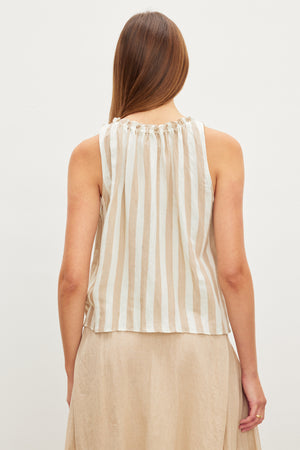 Woman from behind wearing a Velvet by Graham & Spencer ERICA STRIPED LINEN TANK TOP and a beige skirt.