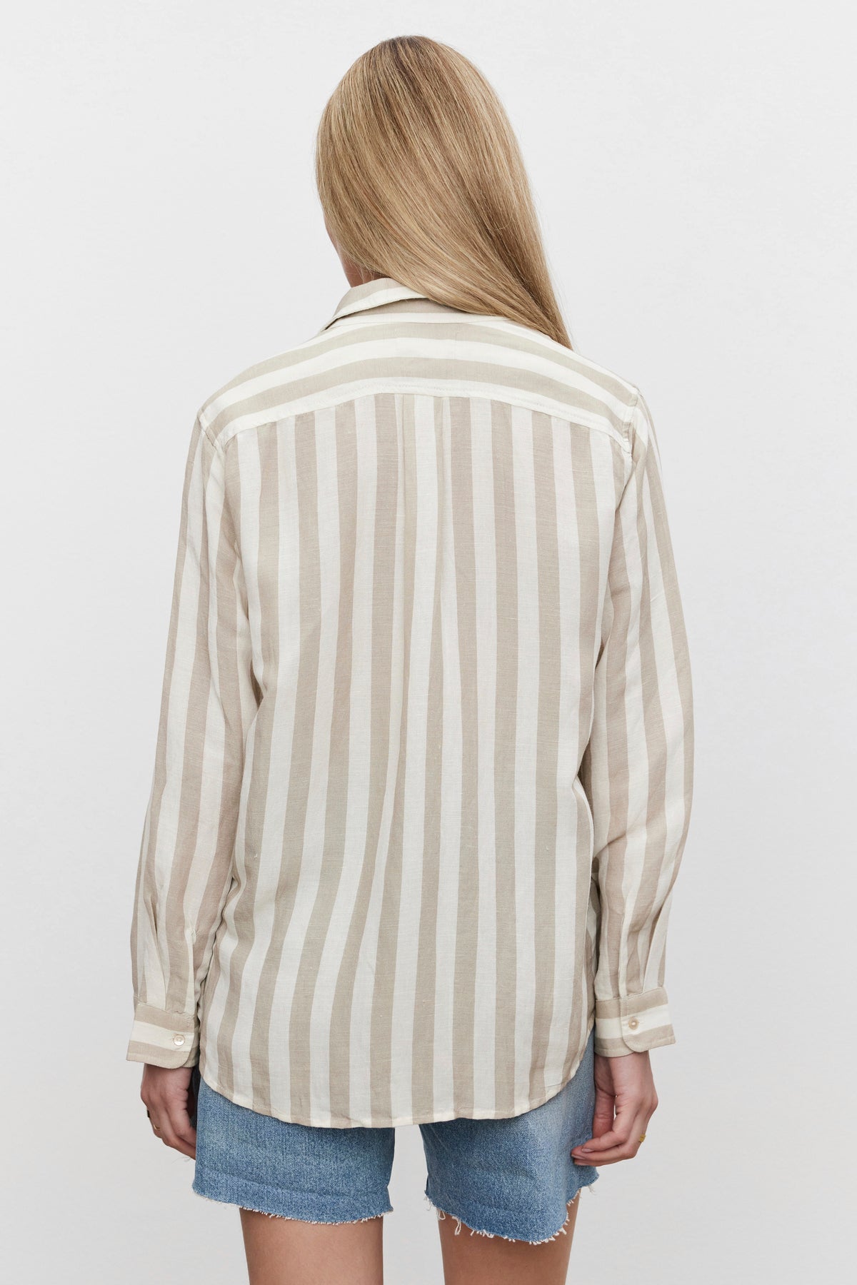   A woman wearing a Velvet by Graham & Spencer HARLOW STRIPED LINEN BUTTON-UP SHIRT in a relaxed fit, shown from the back. 