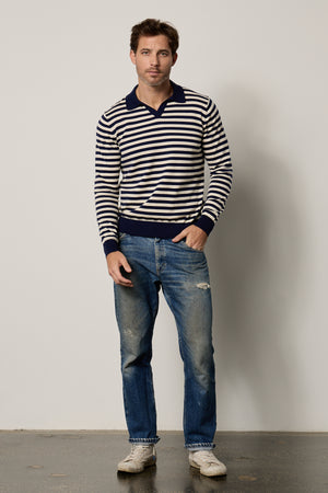 a man wearing the Velvet by Graham & Spencer Ricky Striped Polo and jeans.