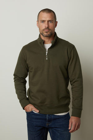 A man in a versatile Velvet by Graham & Spencer BANNING QUARTER-ZIP SWEATSHIRT and jeans.