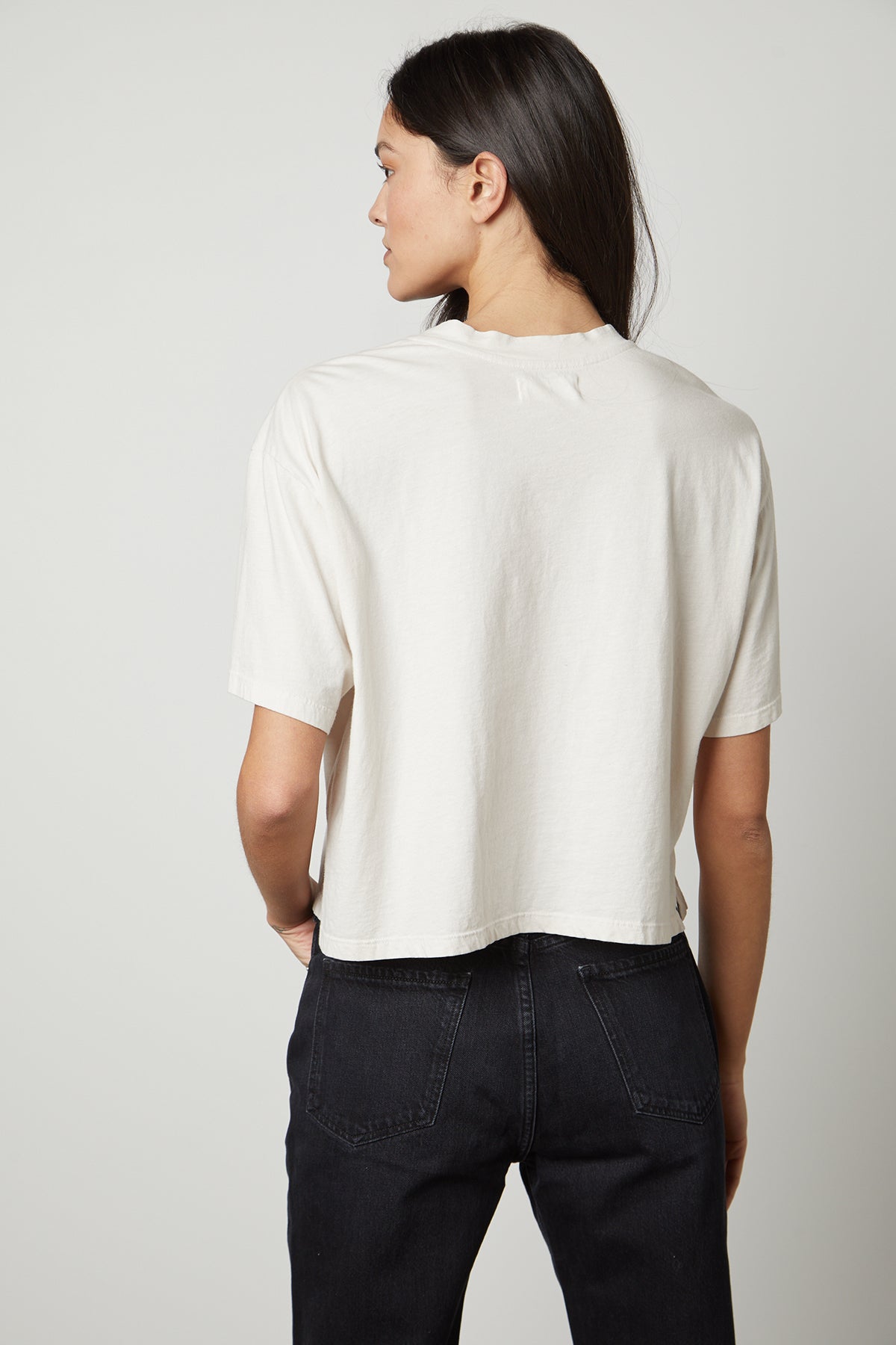 The back view of a woman wearing a Velvet by Graham & Spencer CLARAH CREW NECK TEE.-26799861989569