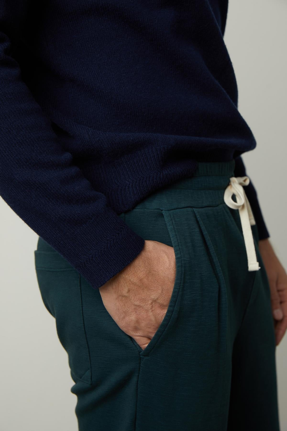 A man wearing a navy sweater and Velvet by Graham & Spencer PARKER SWEATPANT.-35179765006529