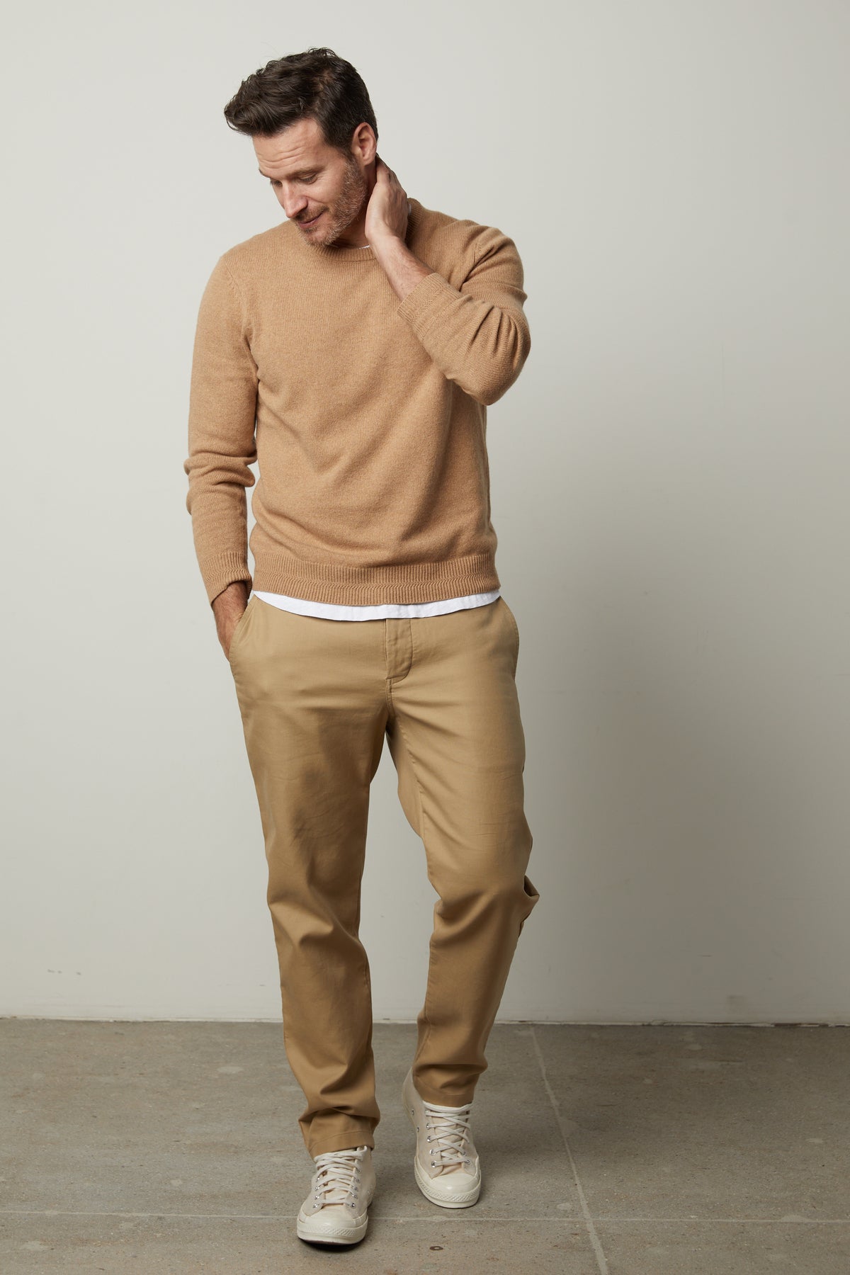   A man exudes style and warmth as he confidently dons a Velvet by Graham & Spencer DASHELL CREW NECK SWEATER. 