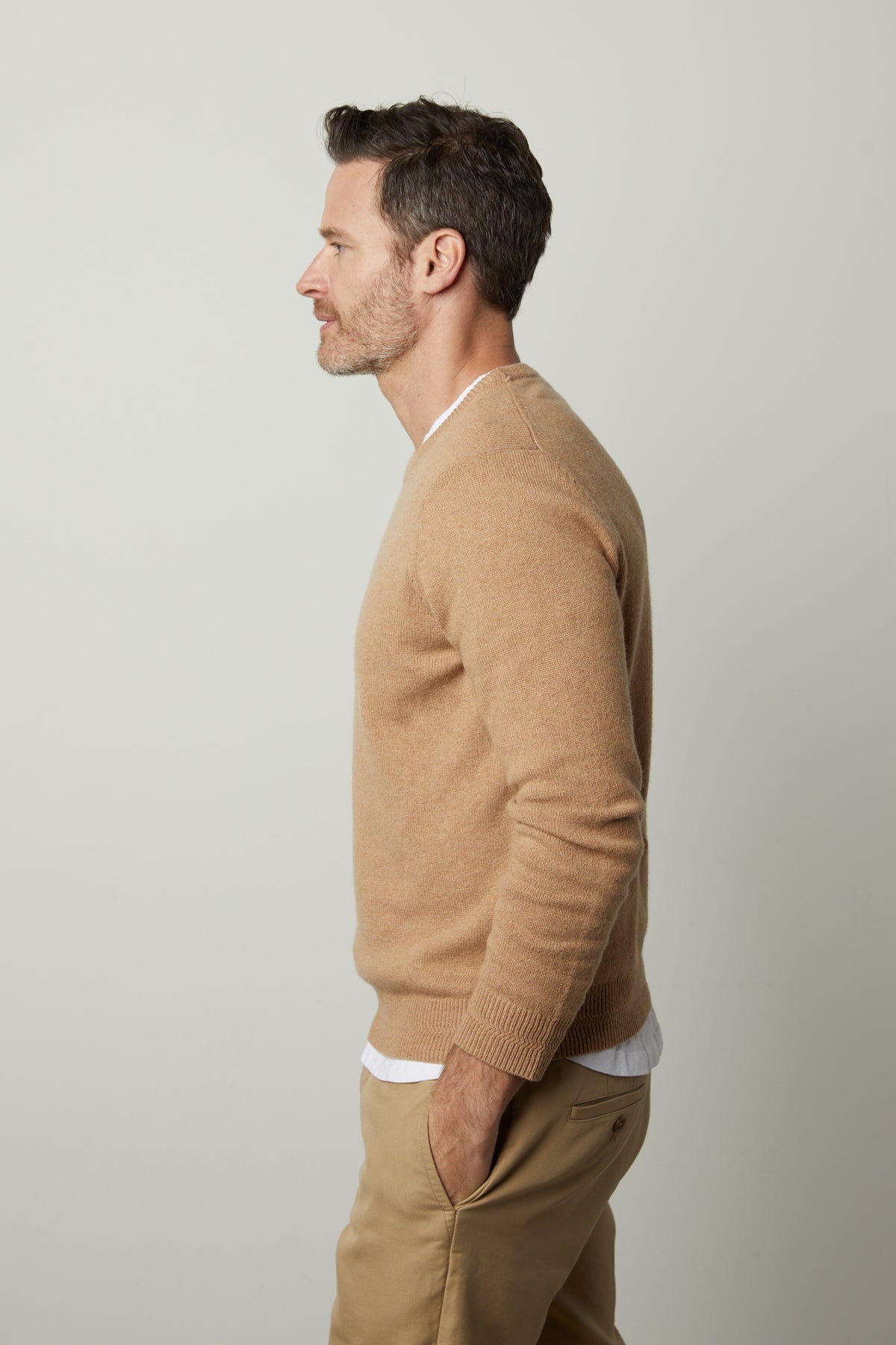 A man exuding warmth and style in a DASHELL CREW NECK SWEATER by Velvet by Graham & Spencer.-35782497173697