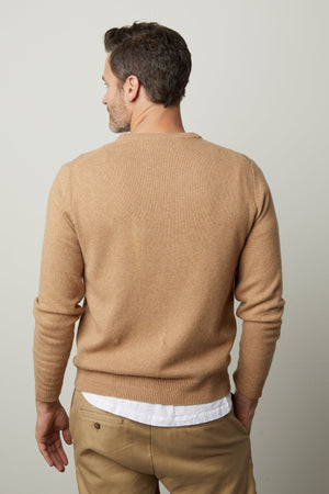 The stylish back view of a man wearing a warm Velvet by Graham & Spencer DASHELL CREW NECK SWEATER.
