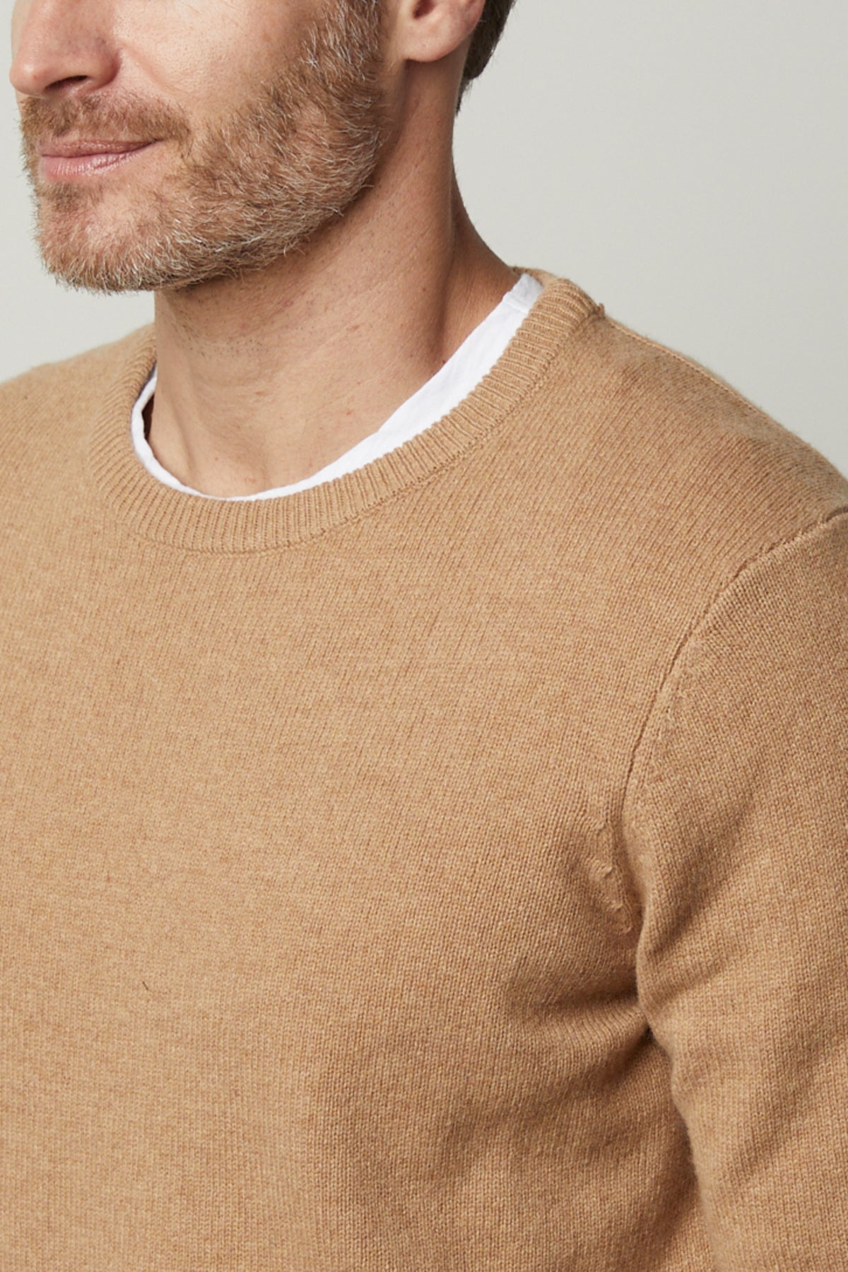   A stylish man dressed in a cozy Velvet by Graham & Spencer DASHELL CREW NECK SWEATER exuding warmth. 