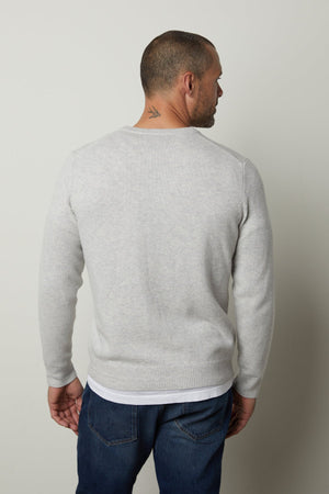 A man showcasing a superior warmth in a Velvet by Graham & Spencer DASHELL CREW NECK SWEATER, exuding a classic look.