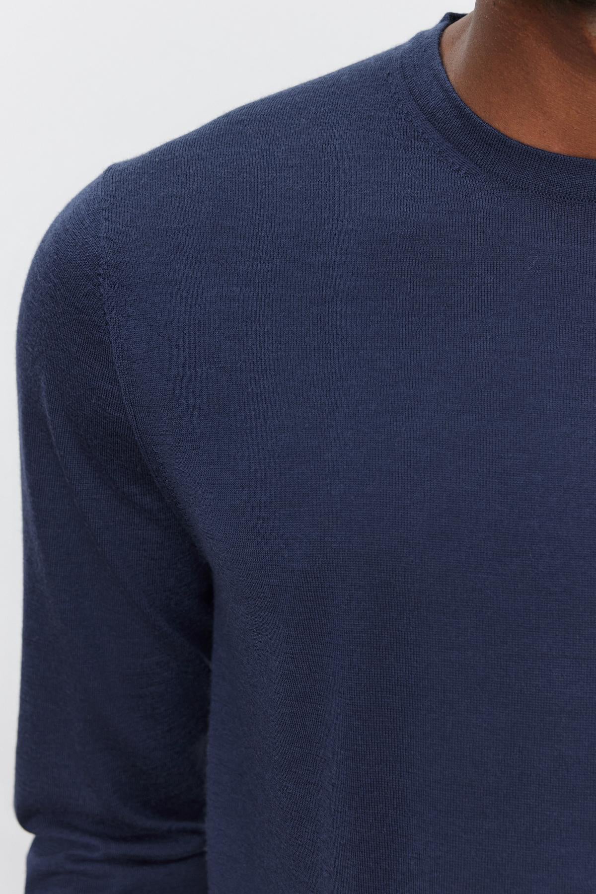   Close-up of a person wearing the ALVIN SWEATER by Velvet by Graham & Spencer. Only the upper torso and part of the neck are visible against a plain background. 