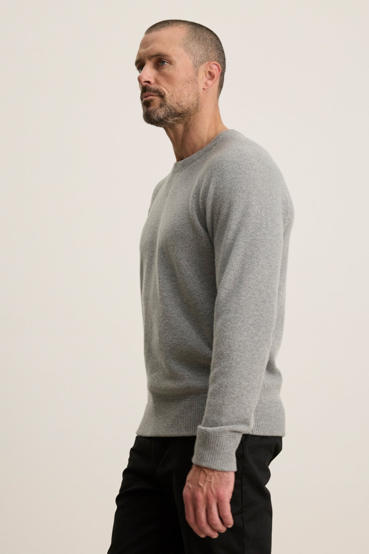 A man in a CORTEZ SWEATER by Velvet by Graham & Spencer.