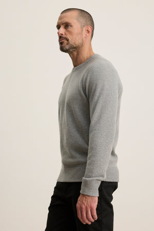 A man in a CORTEZ SWEATER by Velvet by Graham & Spencer.