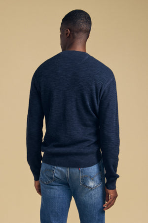 A person viewed from behind wearing a textured navy blue cotton linen blend CONOR SWEATER by Velvet by Graham & Spencer and blue jeans.