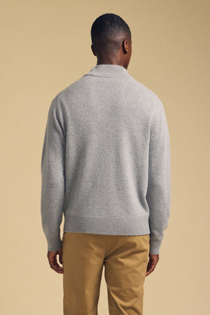 Back view of a person wearing a grey DALLEN FULL-ZIP SWEATER and tan trousers.