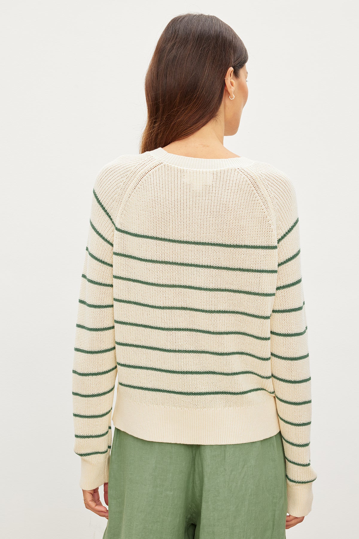 The back view of a woman wearing a Velvet by Graham & Spencer CHAYSE STRIPED CREW NECK SWEATER.-35955537117377