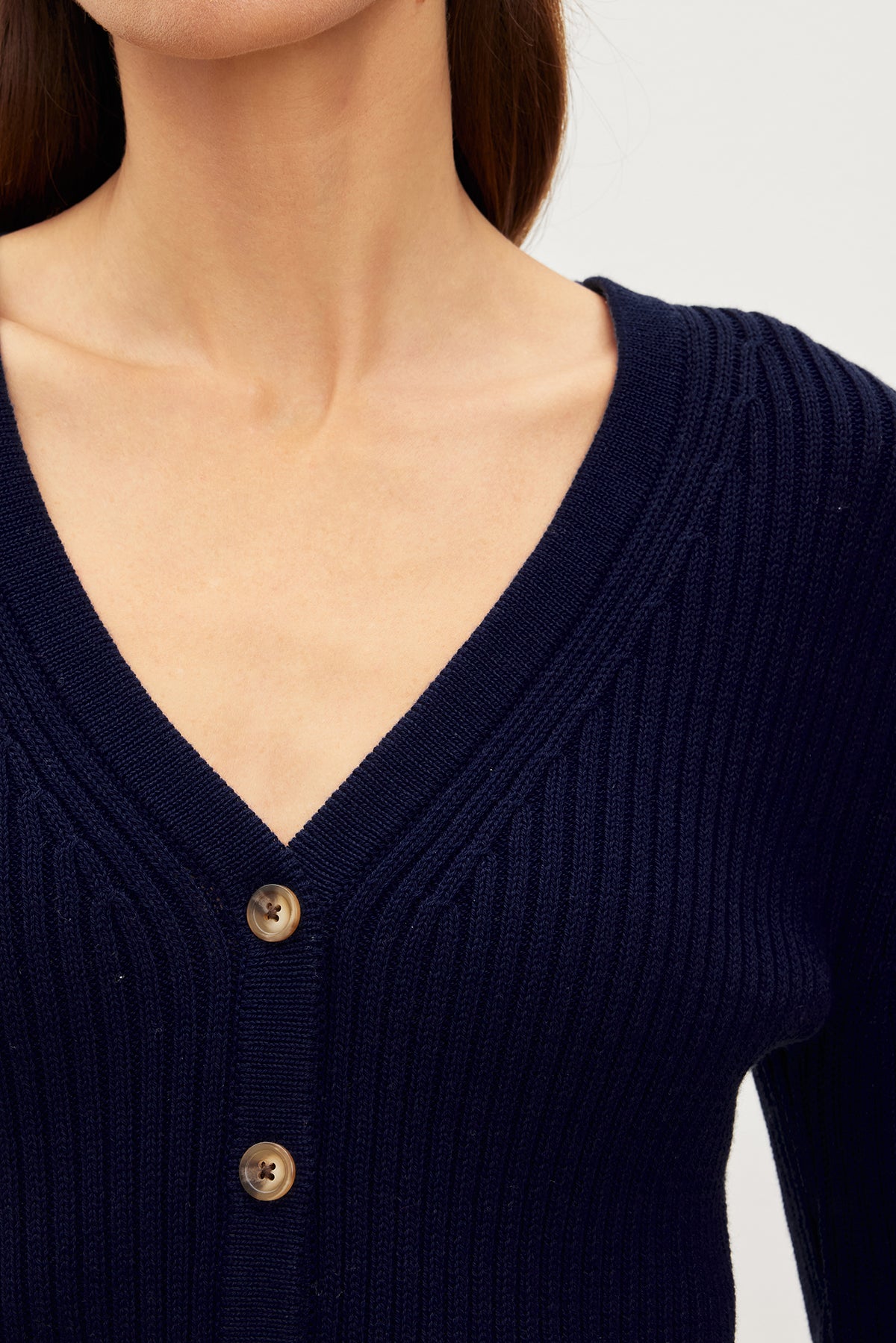   The model is wearing a versatile choice of a Navy HYDIE BUTTON FRONT CARDIGAN by Velvet by Graham & Spencer. 