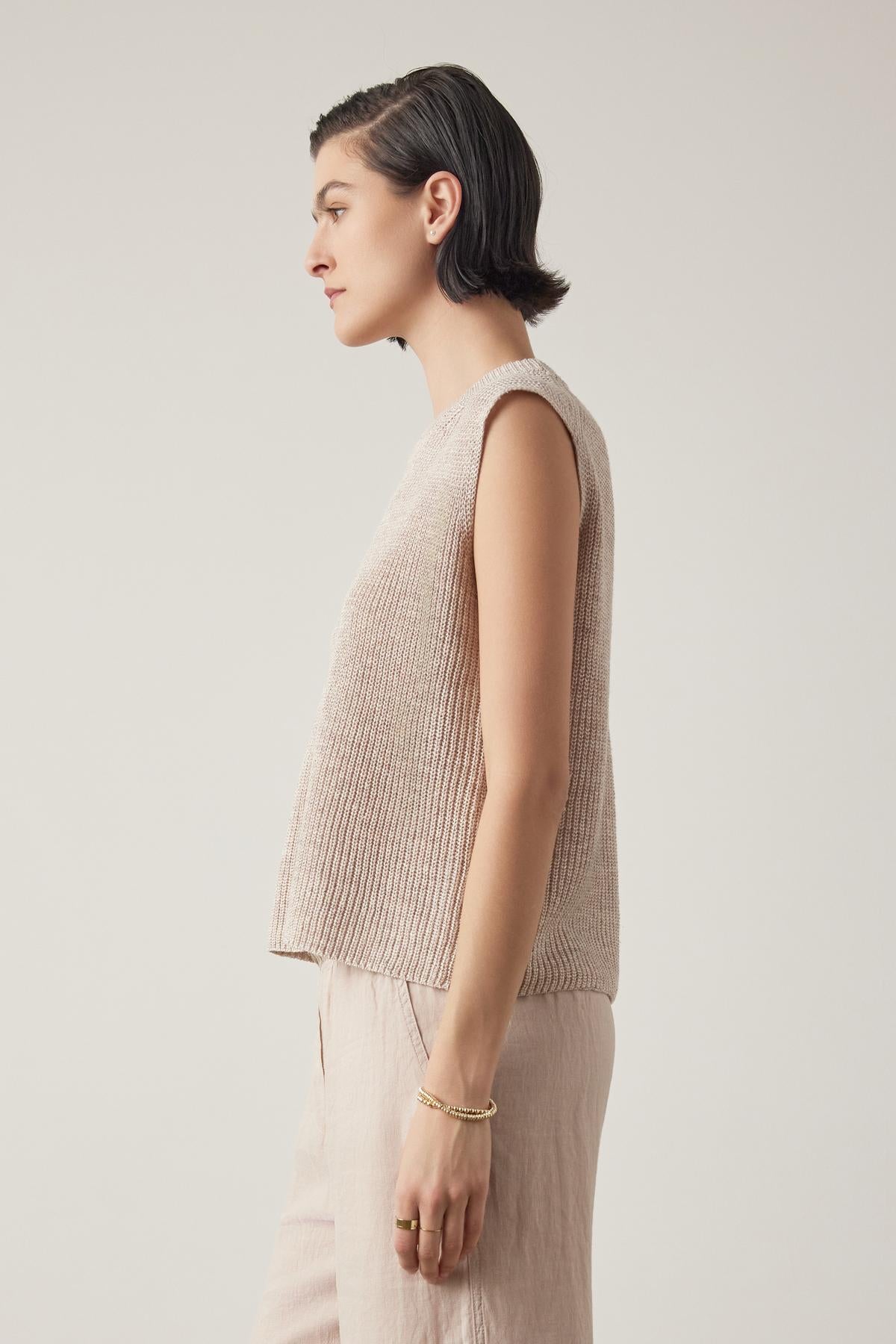 Side profile of a woman with short hair wearing a GARDENA LINEN SWEATER VEST by Velvet by Jenny Graham, standing against a neutral background.-36863284838593