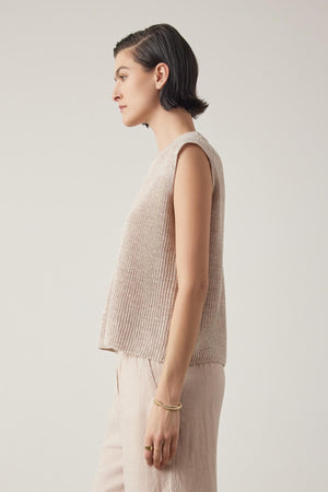 Side profile of a woman with short hair wearing a GARDENA LINEN SWEATER VEST by Velvet by Jenny Graham, standing against a neutral background.