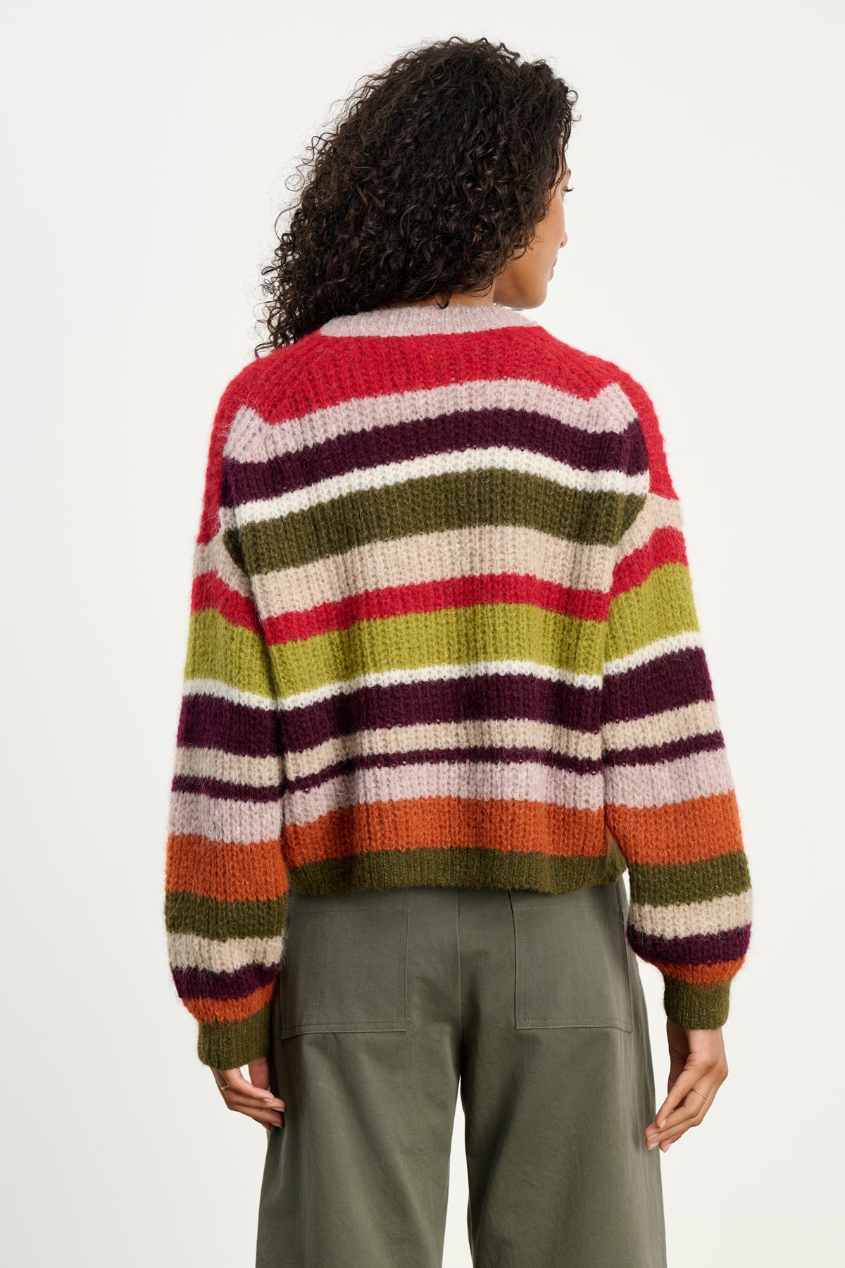 Wearing the RANYA ALPACA CARDIGAN by Velvet by Graham & Spencer, a person with curly hair and olive green pants stands with their back to the camera against a plain background.-39742382768321