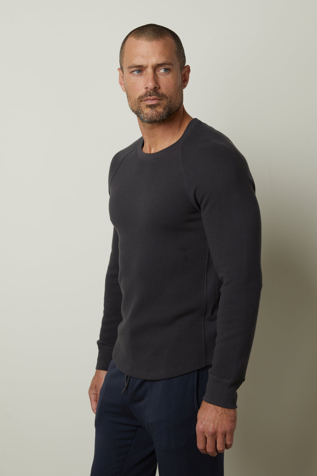 A man wearing a Velvet by Graham & Spencer GLEN THERMAL CREW sweatshirt with a comfortable fit.-35231540216001