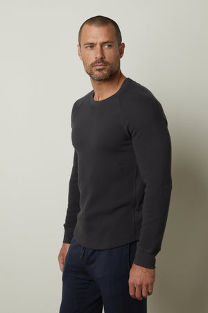 A man wearing a Velvet by Graham & Spencer GLEN THERMAL CREW sweatshirt with a comfortable fit.