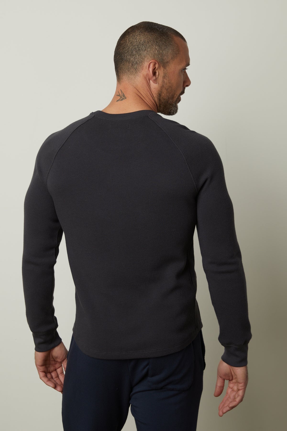   The man wearing a grey sweatshirt has a comfortable fit with the Velvet by Graham & Spencer GLEN THERMAL CREW. 