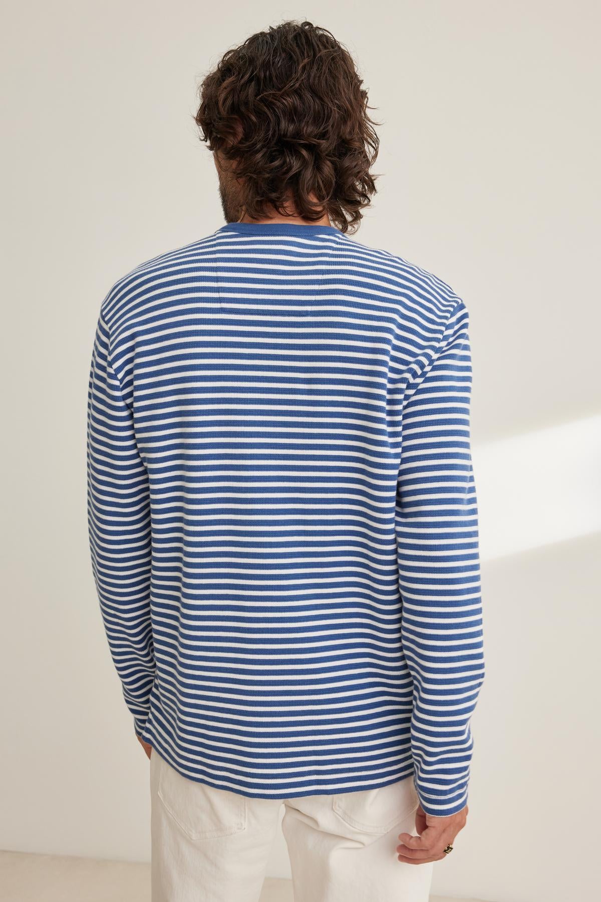   A person wearing the HARLAN THERMAL STRIPED CREW by Velvet by Graham & Spencer stands with their back to the camera against a light background. 