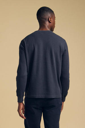 A man seen from the back wearing a dark gray long-sleeve DARIEL THERMAL PULLOVER.