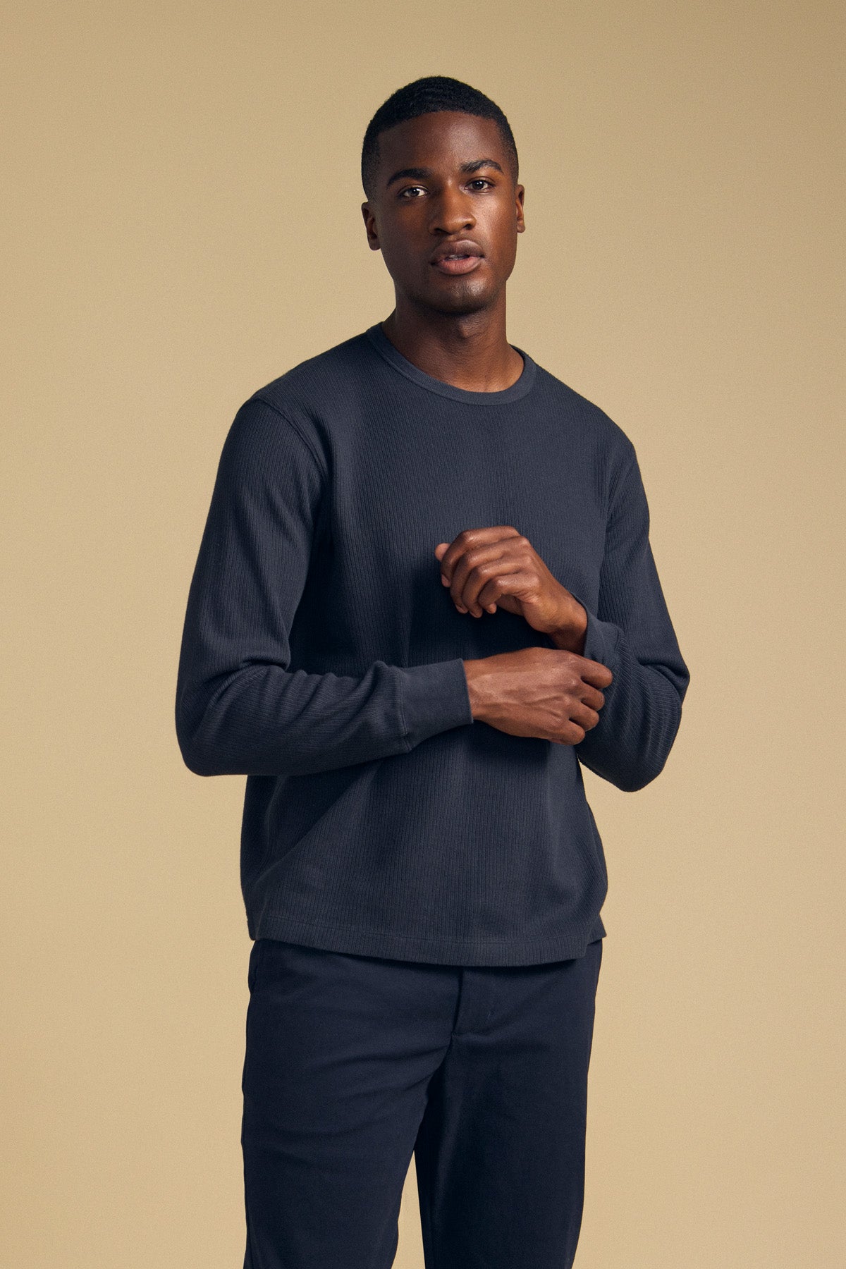A man wearing a charcoal grey 100% cotton thermal crewneck DARIEL THERMAL PULLOVER by Velvet by Graham & Spencer.