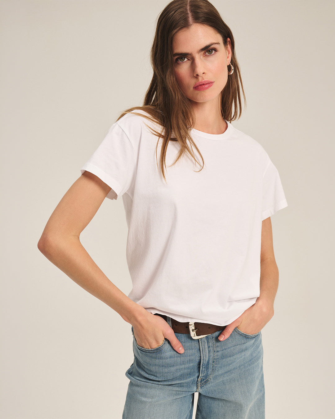A studio image of a woman wearing the Tia Tee in White by Velvet by Graham & Spencer.