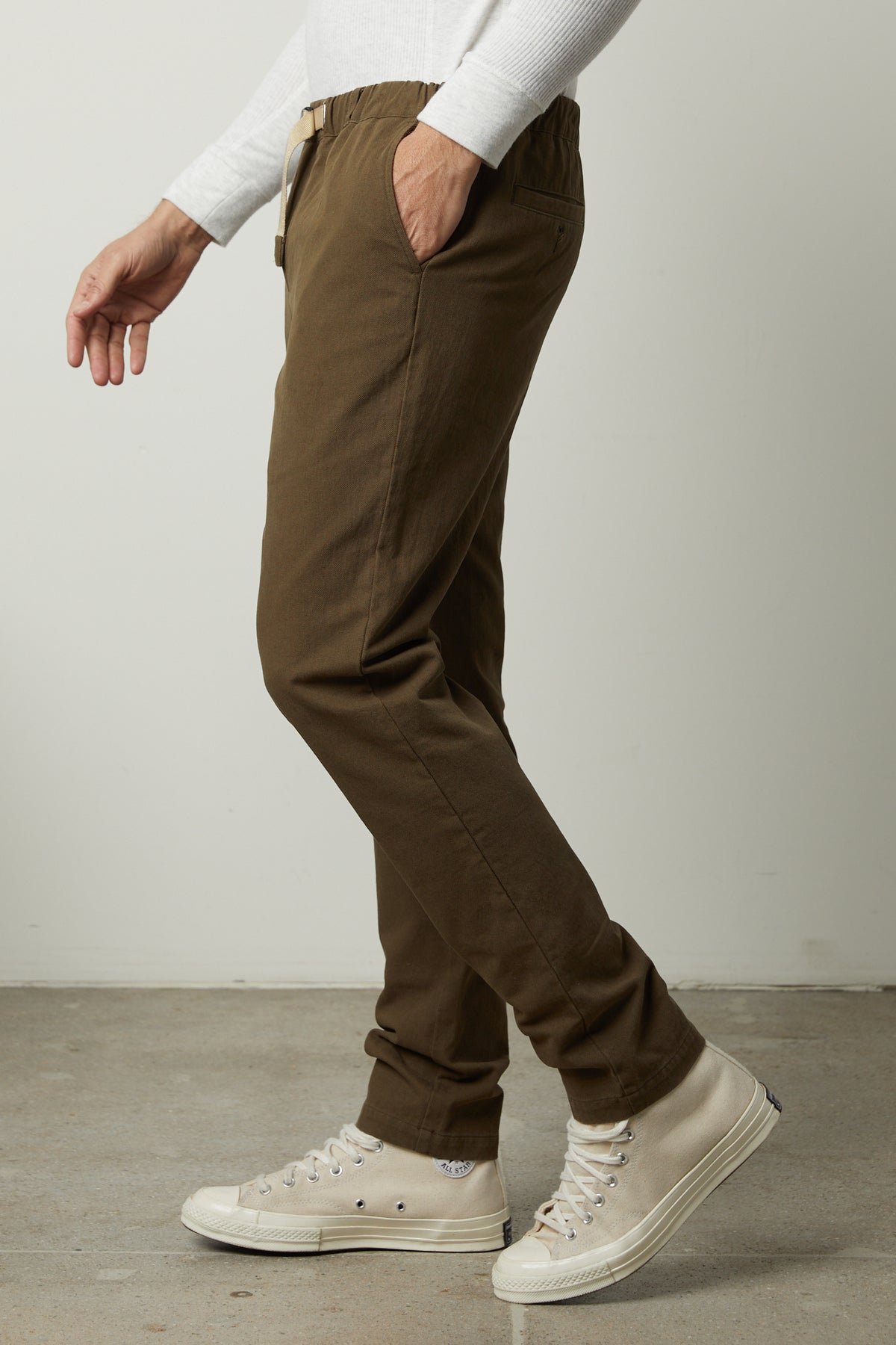   A man wearing Velvet by Graham & Spencer MORAN COTTON TWILL PANT joggers and white sneakers. 