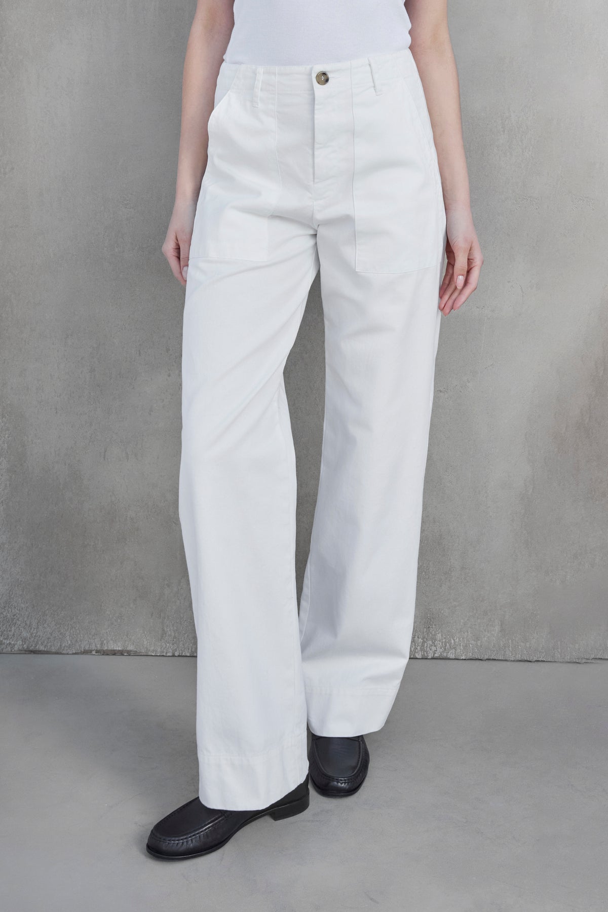 Person wearing high-waisted, wide-leg VENTURA PANT from Velvet by Jenny Graham, paired with a white top and black shoes, standing against a plain gray background.-37659921842369