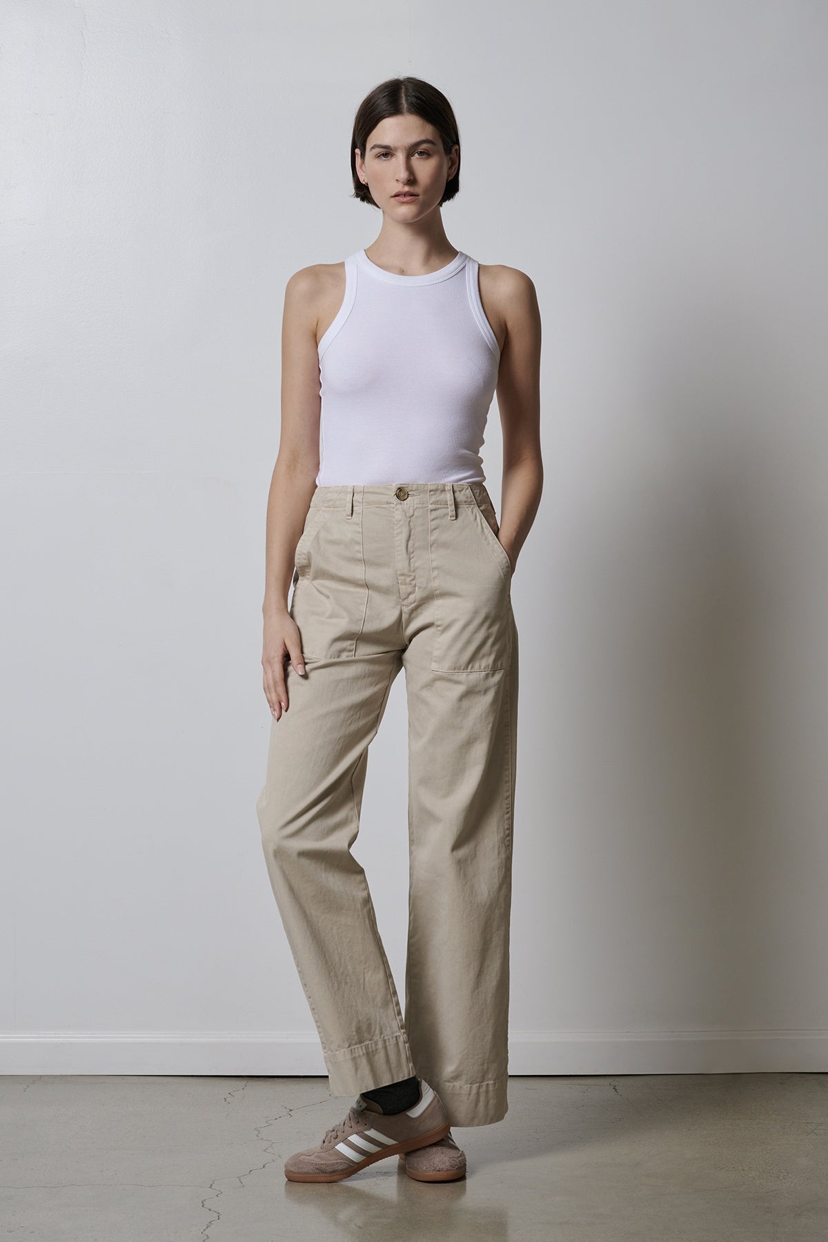 The model is wearing a white Velvet by Jenny Graham Cruz tank top that fits perfectly with khaki pants.-35417028001985