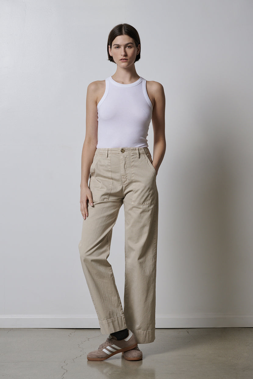 The model is wearing a white Velvet by Jenny Graham Cruz tank top that fits perfectly with khaki pants.