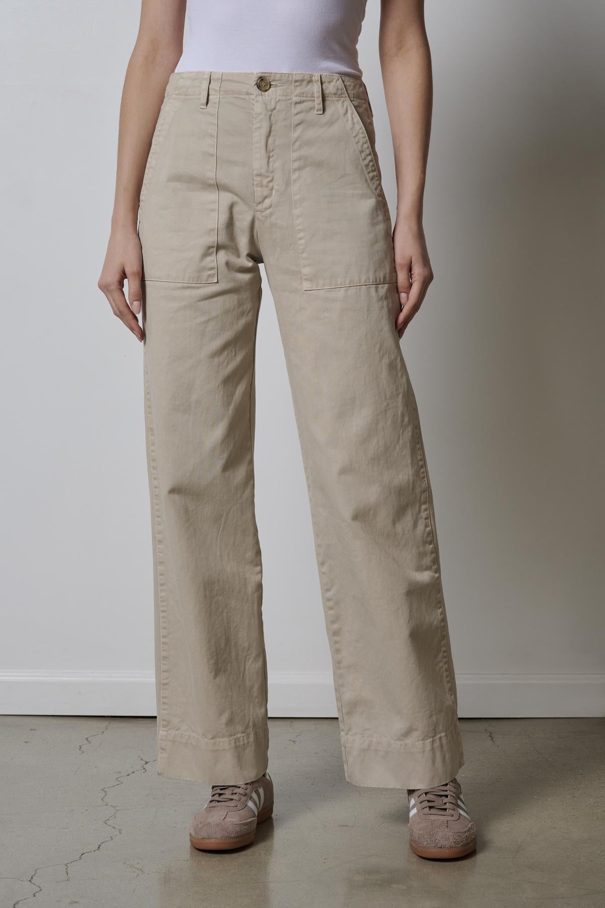   A woman wearing Velvet by Jenny Graham's VENTURA PANT in beige and a white top. 