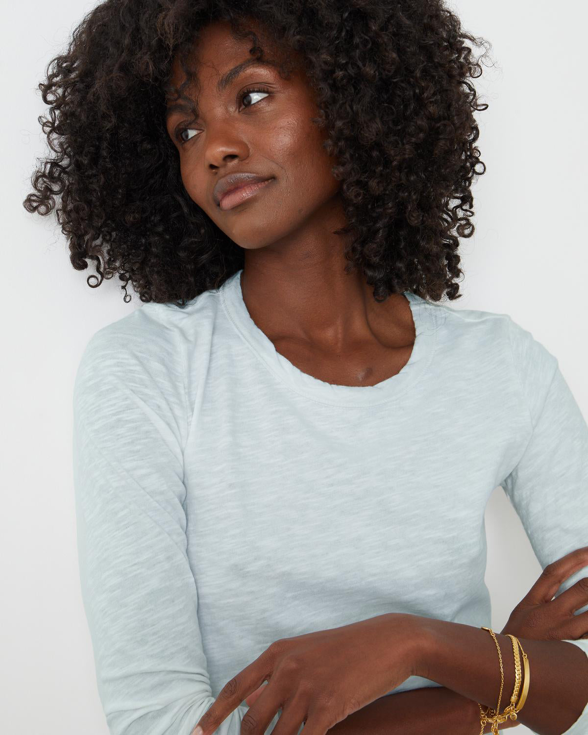 A black woman wearing a Velvet by Graham & Spencer LIZZIE ORIGINAL SLUB LONG SLEEVE TEE.-35982858813633