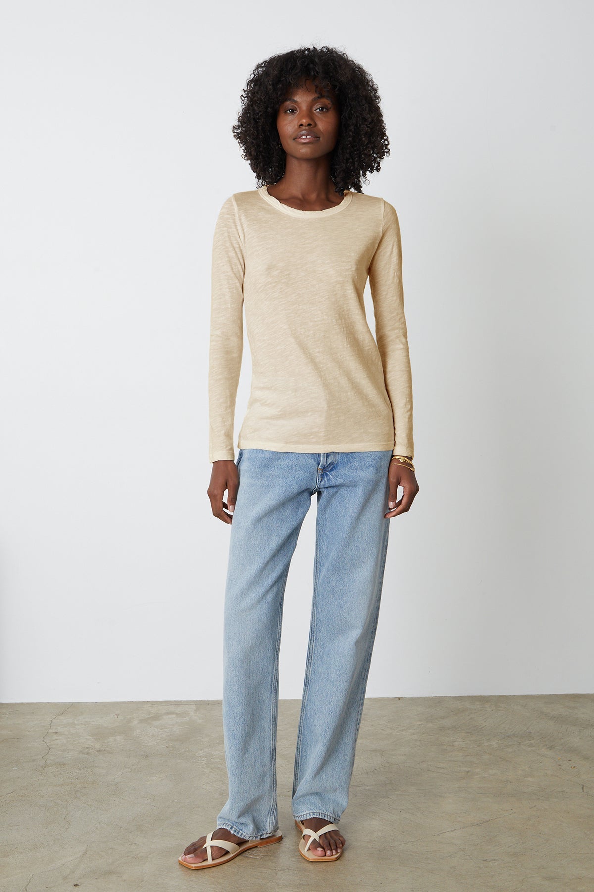 Lizzie long sleeve tee in sesame with light blue denim and flat sandals full length front-26630740476097