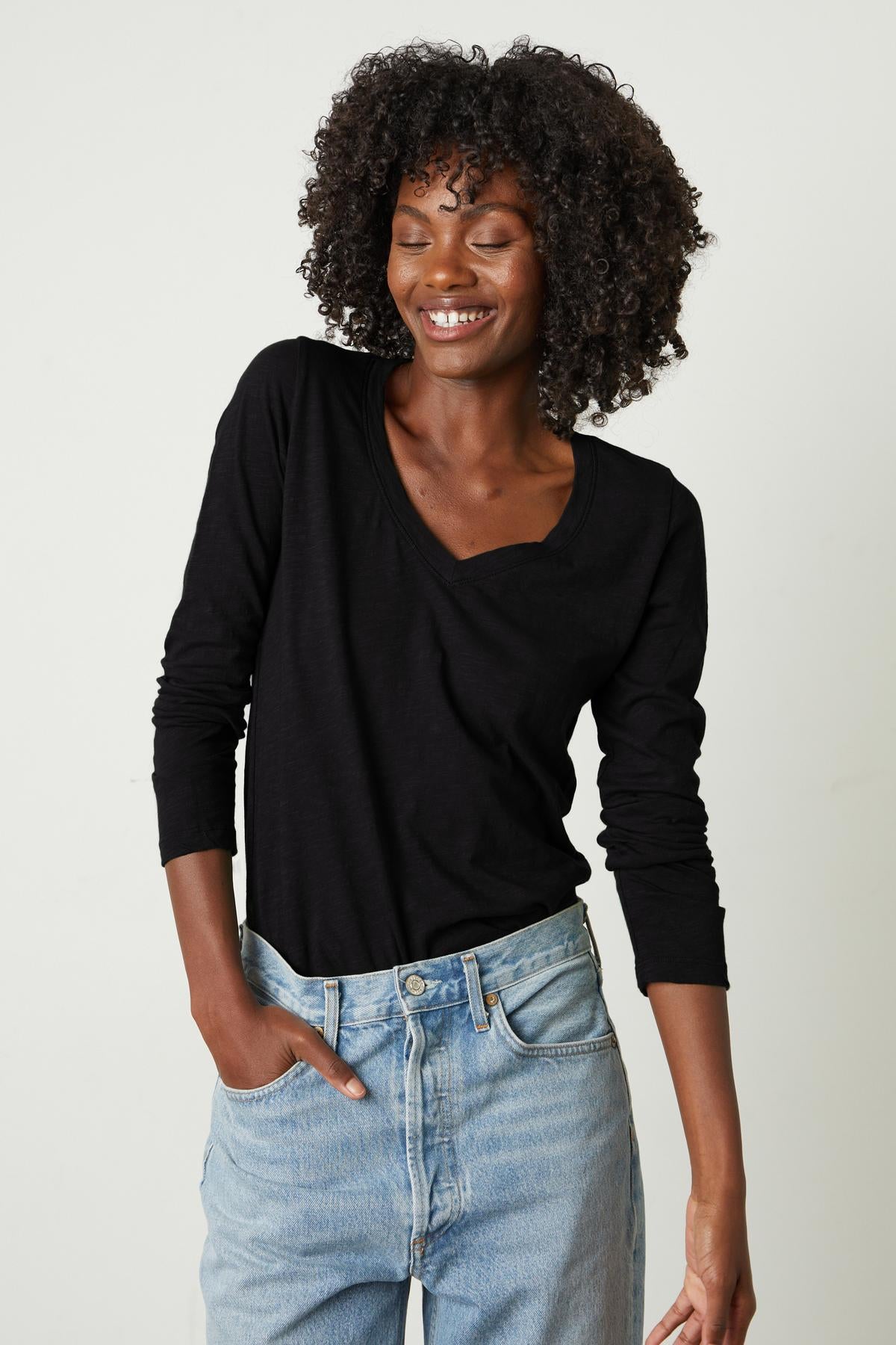   A woman wearing a Velvet by Graham & Spencer BLAIRE ORIGINAL SLUB TEE made of whisper-soft cotton. 