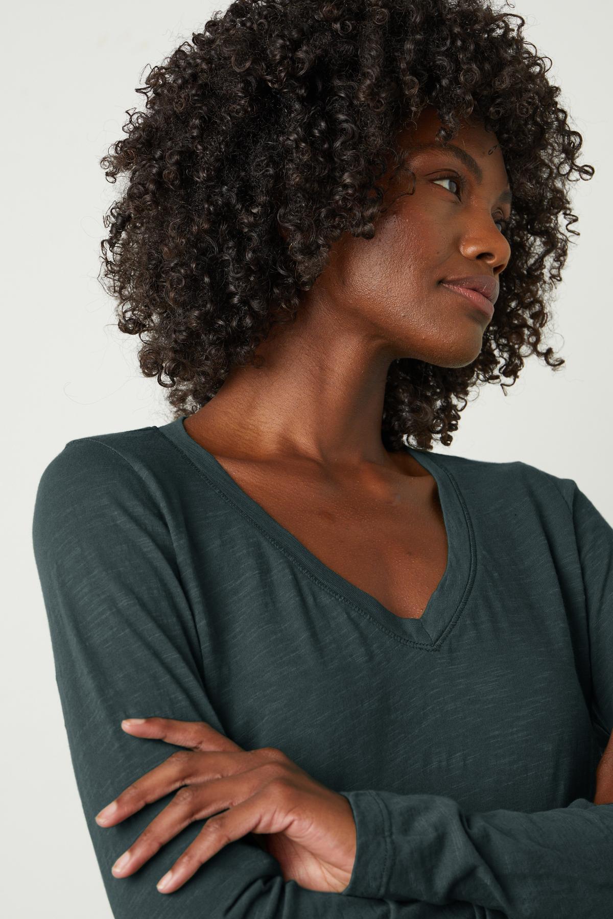 A woman wearing a whisper-soft Blaire Original Slub Tee v-neck top by Velvet by Graham & Spencer.-35782759514305