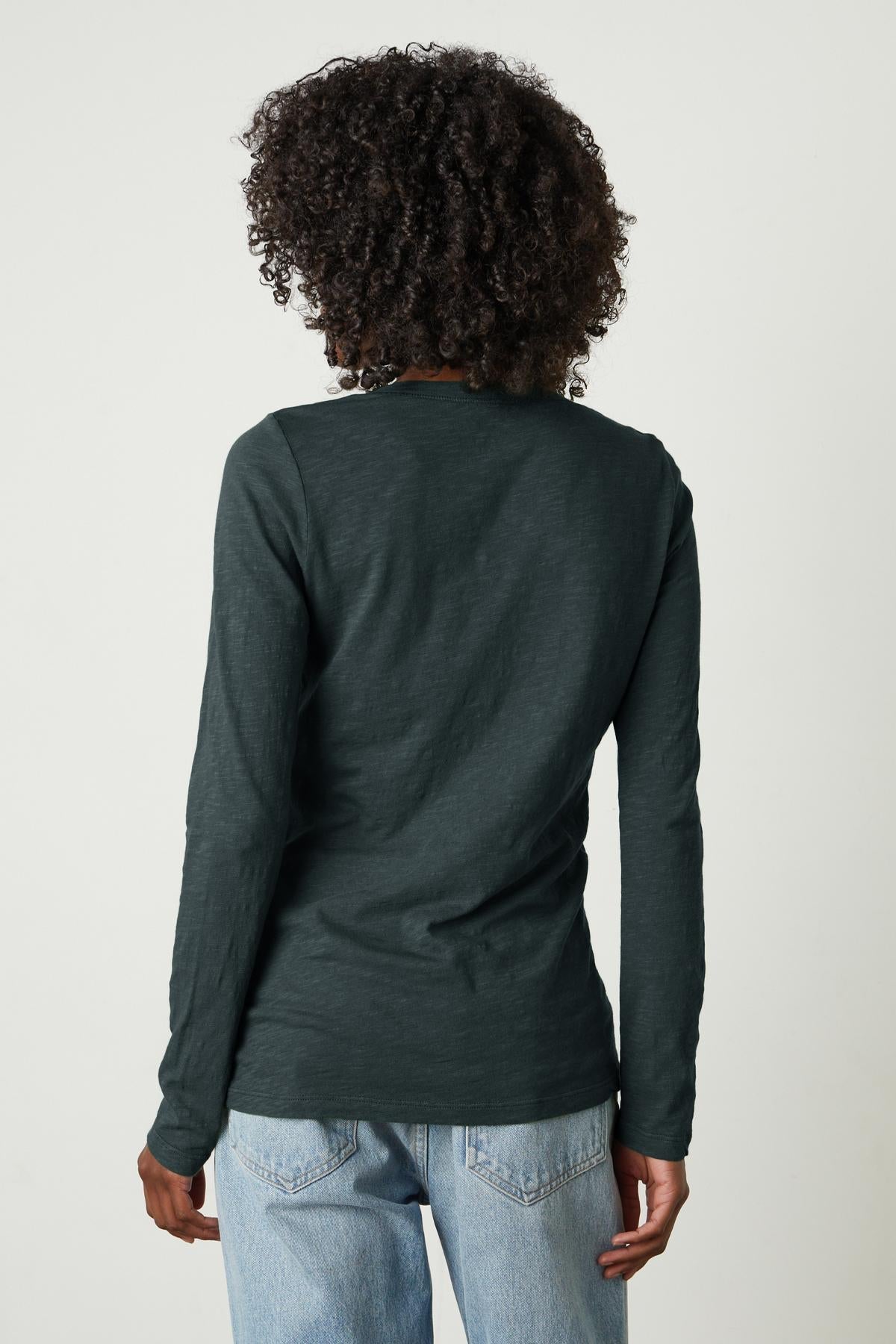   The back view of a woman wearing Velvet by Graham & Spencer's BLAIRE ORIGINAL SLUB TEE jeans. 