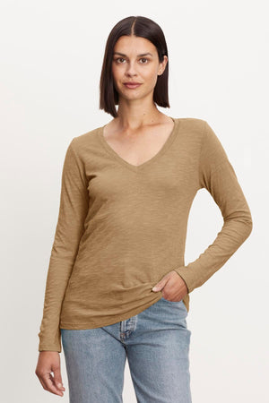 A woman wearing a Velvet by Graham & Spencer BLAIRE ORIGINAL SLUB TEE tan v - neck t - shirt.