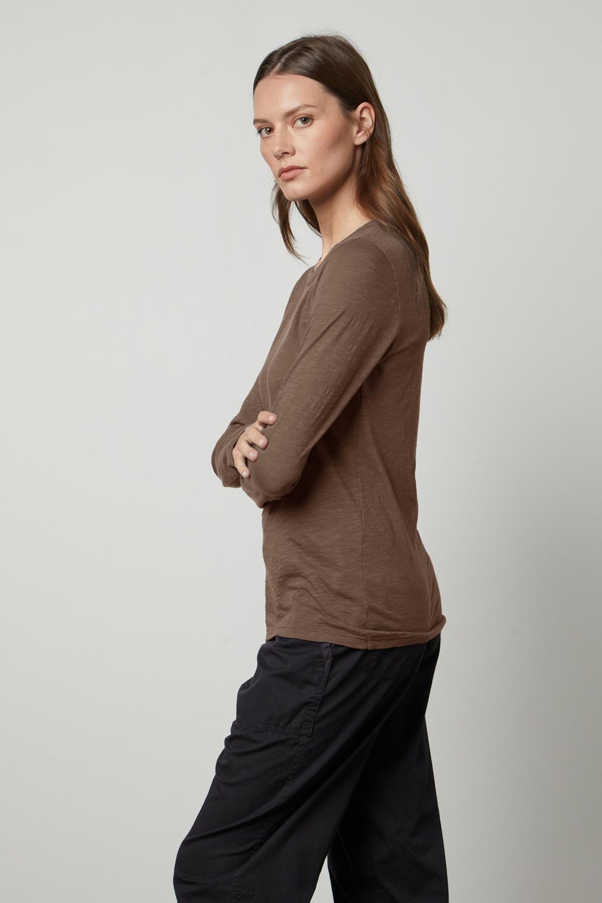   The model is wearing a Velvet by Graham & Spencer LIZZIE ORIGINAL SLUB LONG SLEEVE TEE made of cotton. 