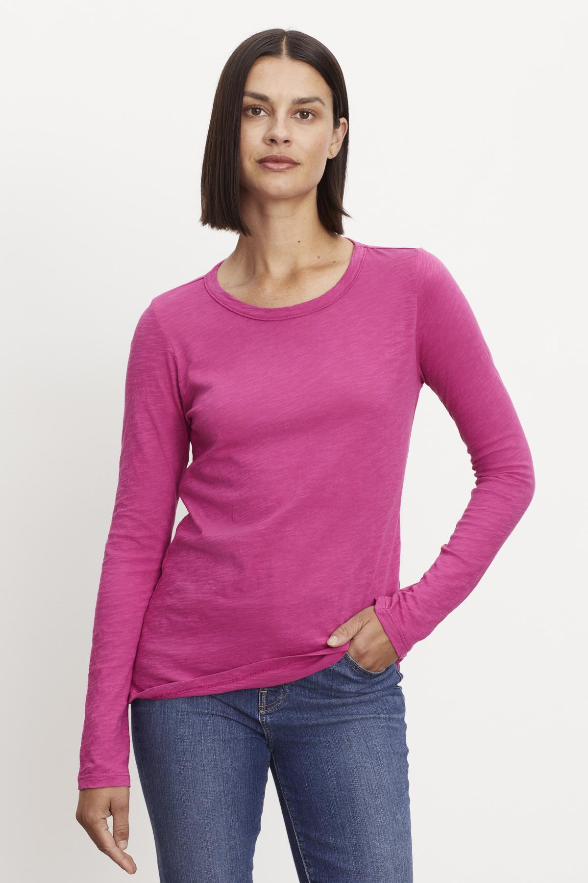   A woman wearing a LIZZIE ORIGINAL SLUB LONG SLEEVE TEE by Velvet by Graham & Spencer in cotton. 