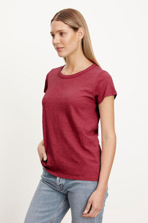 A woman wearing a Velvet by Graham & Spencer burgundy TILLY ORIGINAL SLUB CREW NECK TEE and jeans.