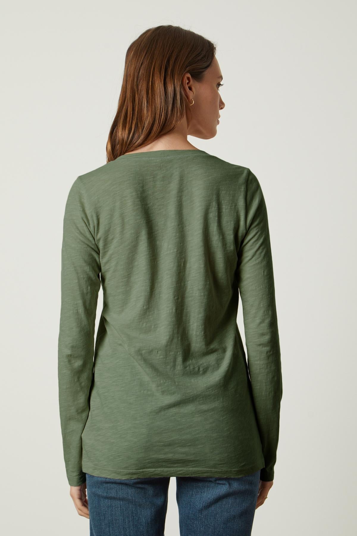The back view of a person wearing jeans and a Velvet by Graham & Spencer BLAIRE ORIGINAL SLUB TEE.-35782759284929