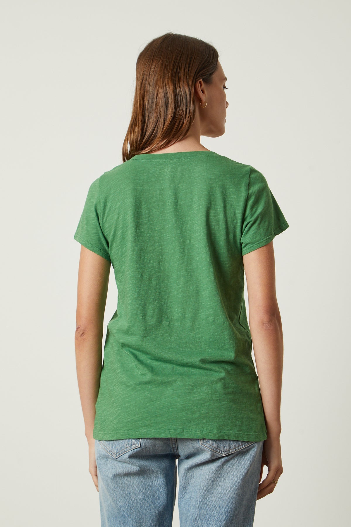 the back view of a woman wearing a Velvet by Graham & Spencer JILIAN ORIGINAL SLUB V-NECK TEE.-26630509887681